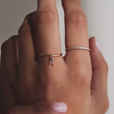 Custom Initial Birthstone Ring featuring a pavé diamond band and dangling gemstone accent