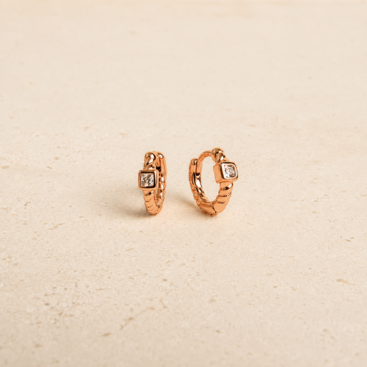rose gold huggies with white background