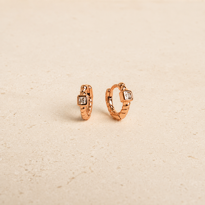 rose gold huggies with white background