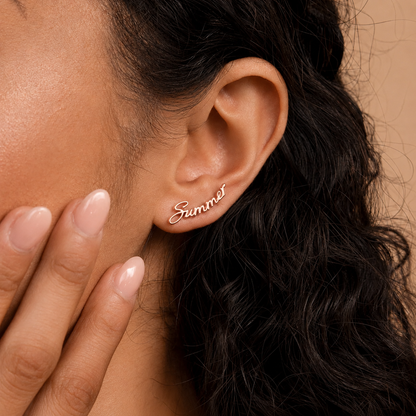 Close-up of an ear wearing a 'Summer' earring with a hand touching the cheek.
