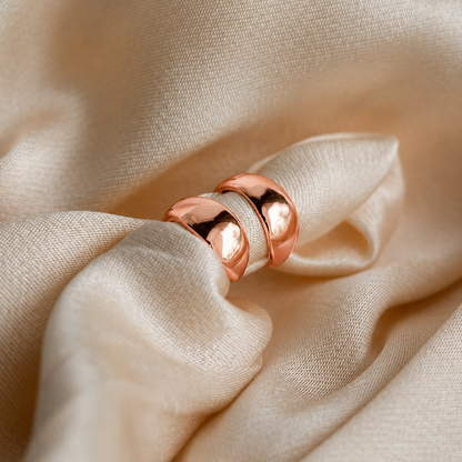 Rose gold ring on beige fabric