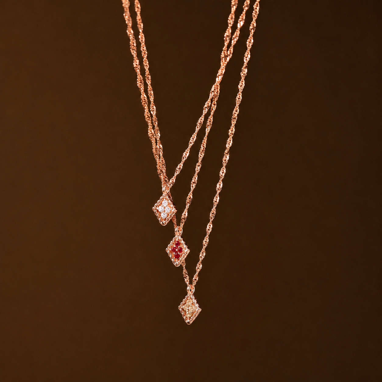 Rose gold necklace with gemstones on a dark brown background