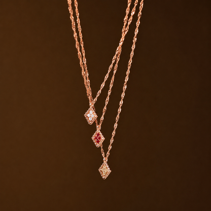 Rose gold necklace with gemstones on a dark brown background