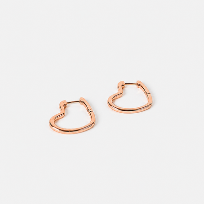 Rose gold hoop earrings on a light gray background