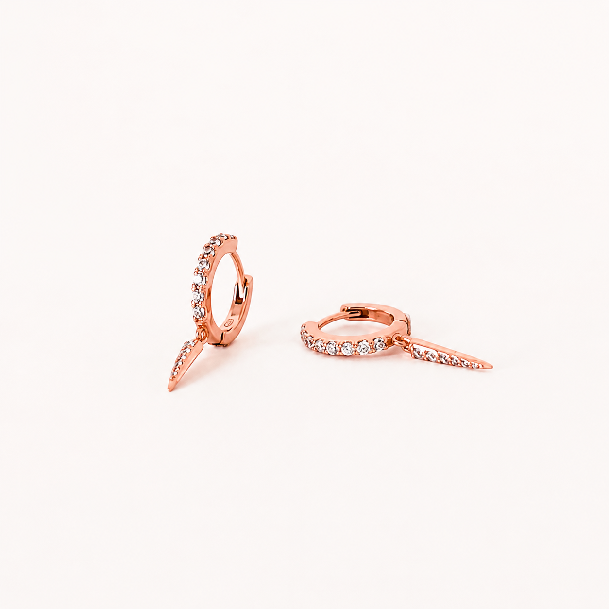 Rose gold earrings on a white background