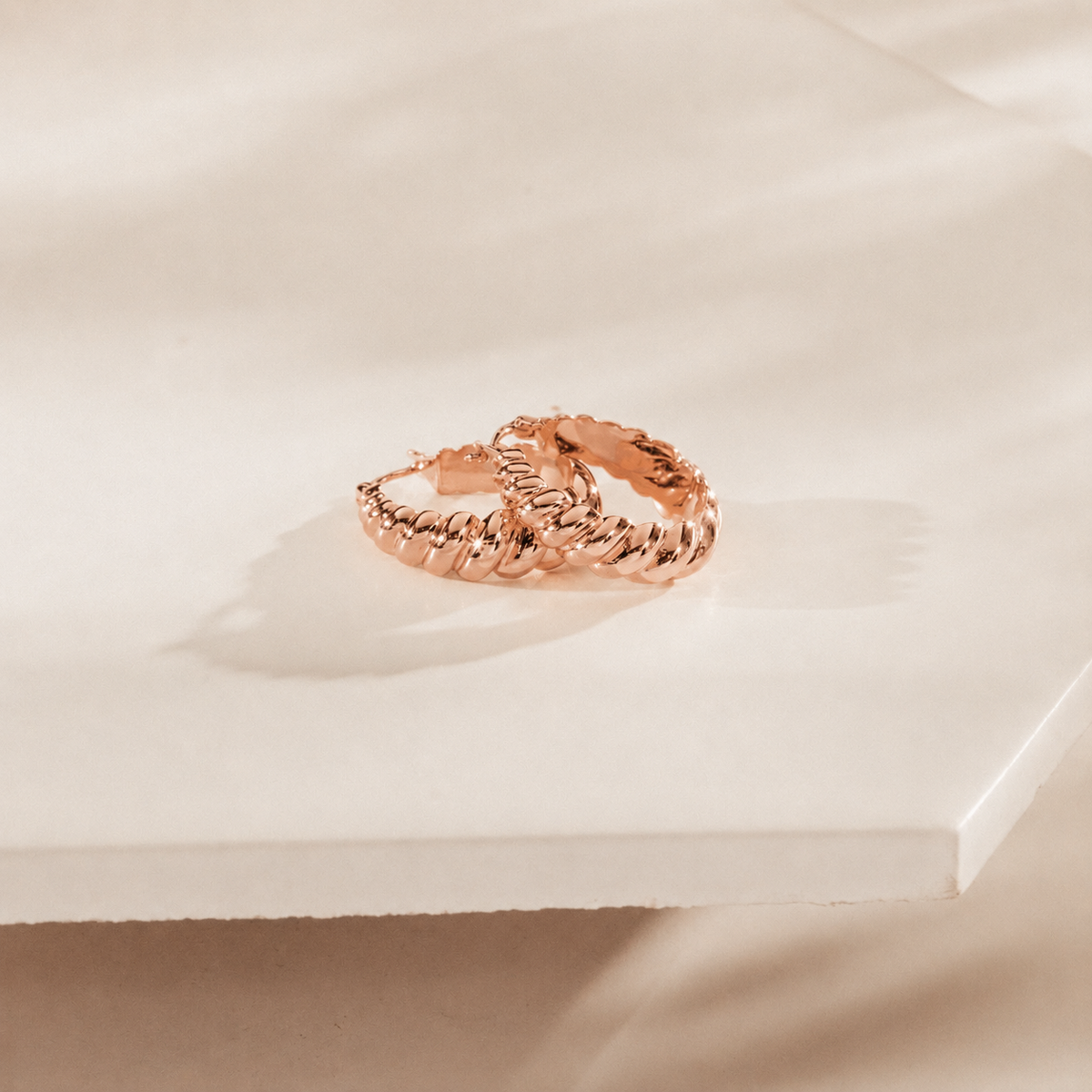 Rose gold ring on a soft beige background