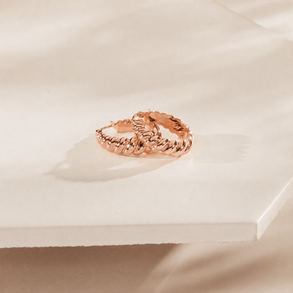 Rose gold ring on a soft beige background