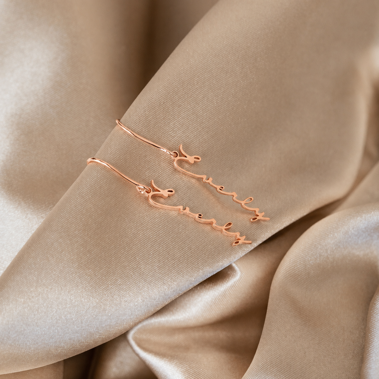 Rose gold bracelet on a beige fabric background