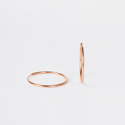 Hoop in rose gold plating with white background