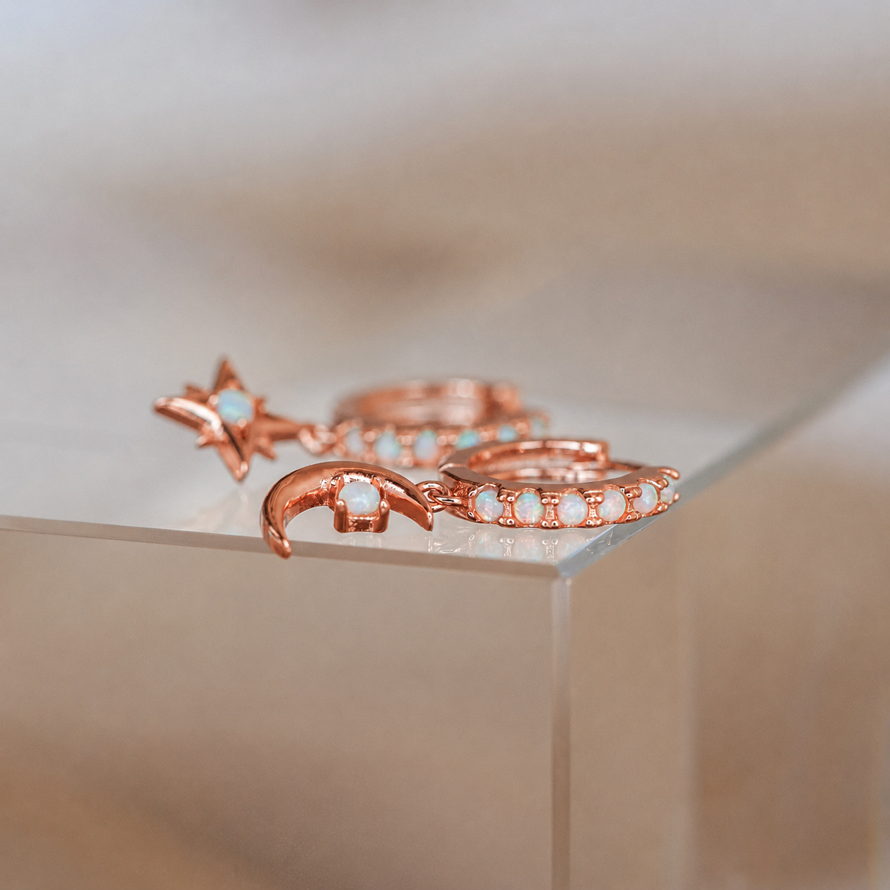 Rose gold rings with gemstones on a neutral background