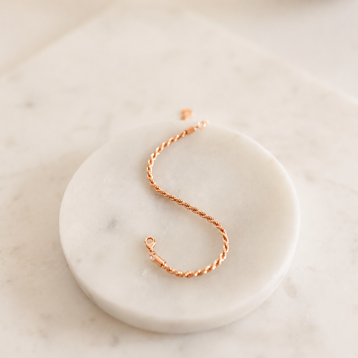 Rose gold bracelet on a marble surface