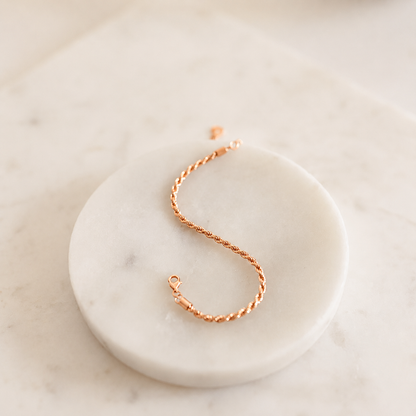 Rose gold bracelet on a marble surface