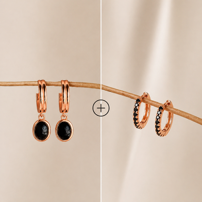 Rose gold hoop earrings with black stones on a beige background