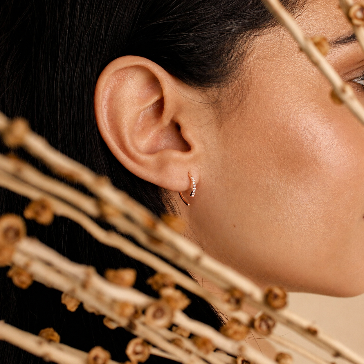 Close-up of a person's ear with an earring, focusing on the jewelry.