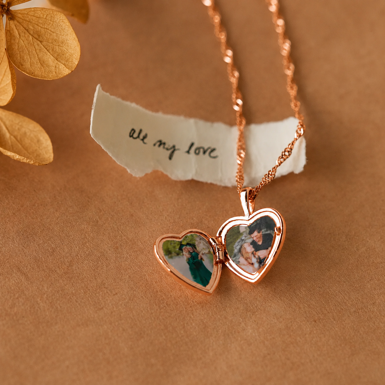 Rose gold heart-shaped locket with photos on a brown background with 'all my love' text.