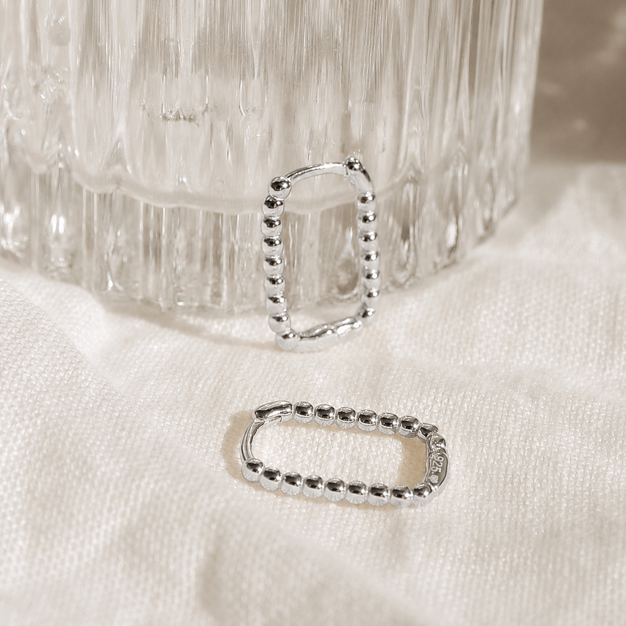 Silver belt buckle on a textured white surface
