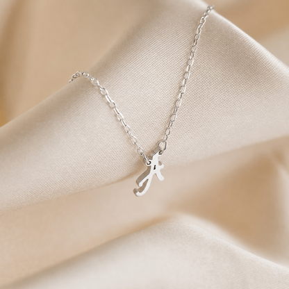Silver necklace with a unique pendant on a beige fabric background