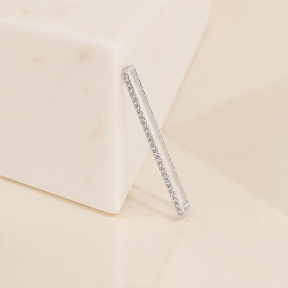 Clear hair straightener with embedded rhinestones on a beige background
