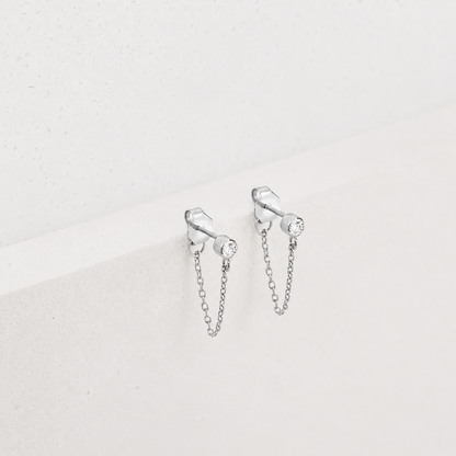 Silver chain earrings on a light gray background