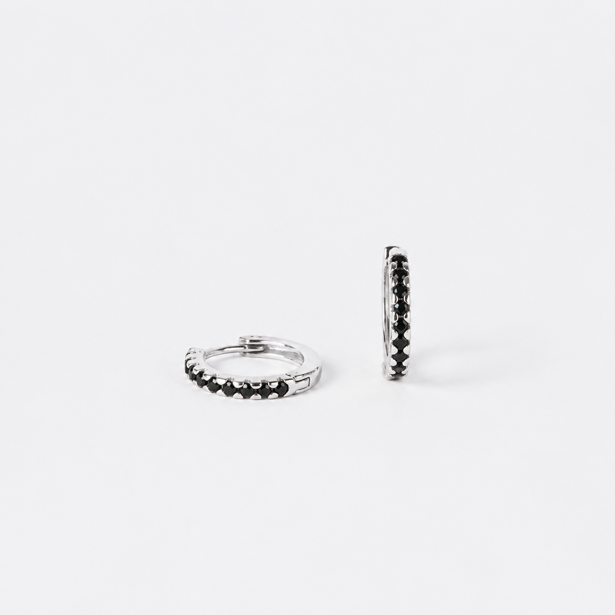 Two silver hoop earrings on a white background