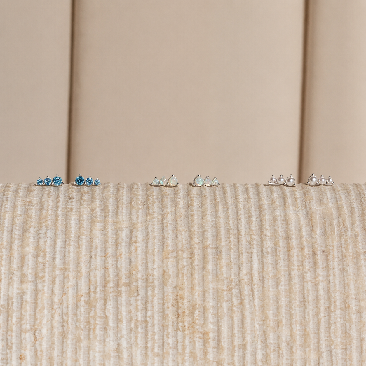 Small decorative items on a textured surface with a neutral background