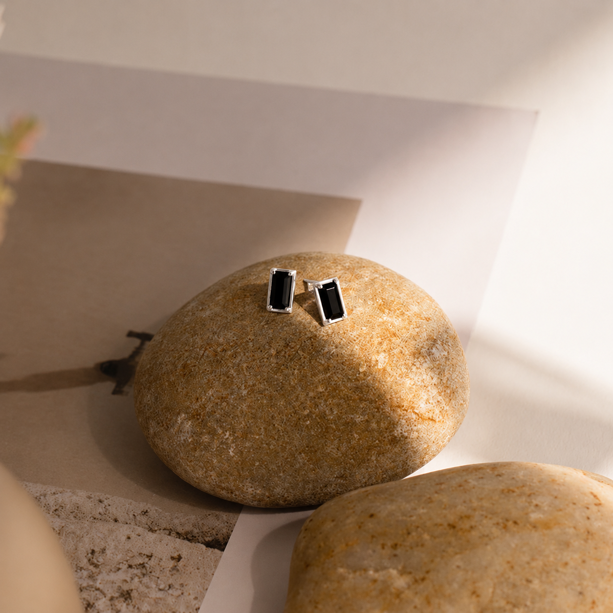Cufflinks on a rock with a neutral background