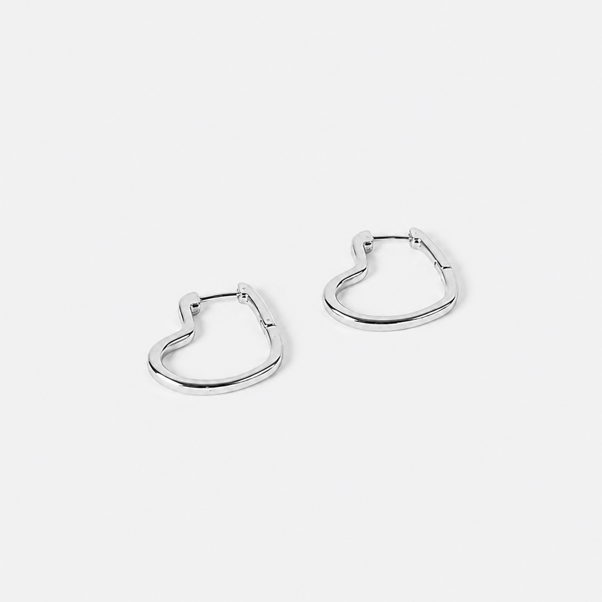 Pair of silver hoop earrings on a light gray background