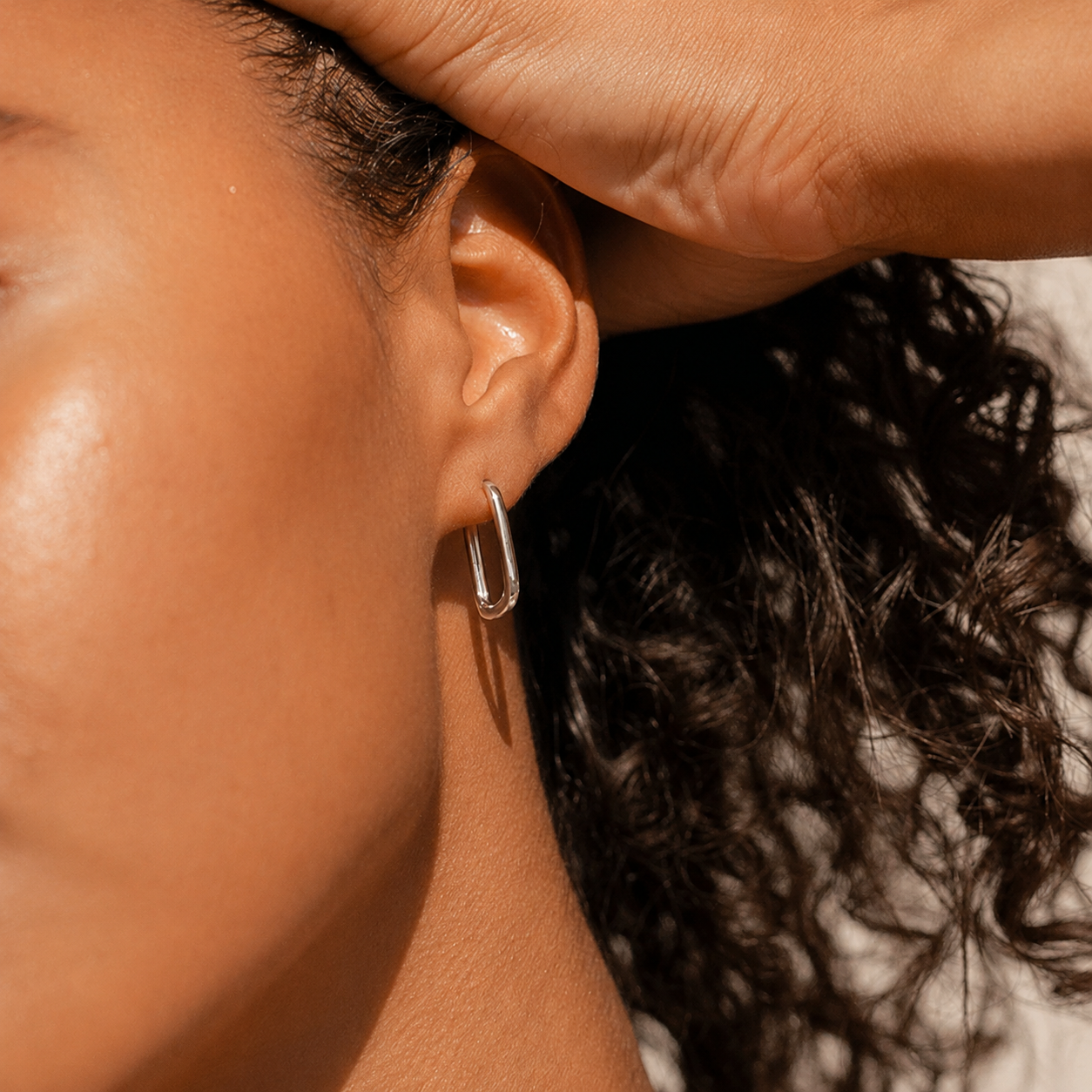 Close-up of a person's ear with an earring, focusing on the jewelry.