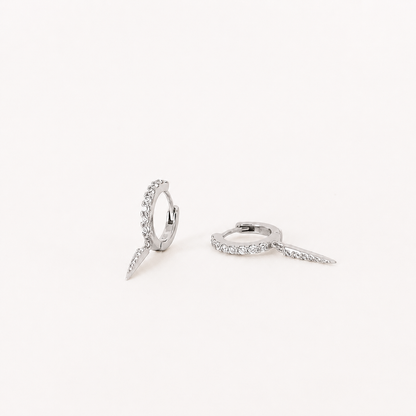Silver ring with diamond accents on a white background