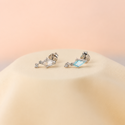 Pair of earrings with gemstones on a beige background