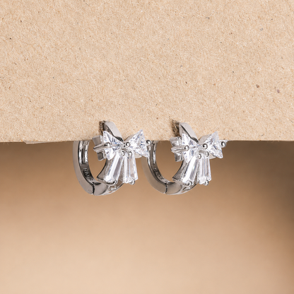 Diamond hoop earrings on a beige background