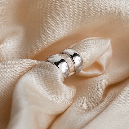 Silver ring on a beige fabric background