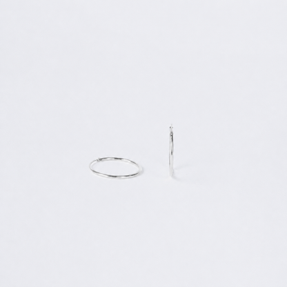 Two silver hoop earrings on a white background