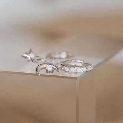 Silver rings with gemstones on a reflective surface