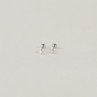 Pair of silver stud earrings on a light gray background