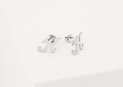 Silver earrings with letter 'M' and 'Y' on a white background