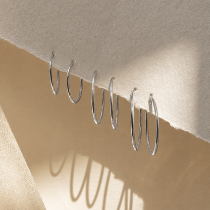 Silver hooks on a beige fabric background