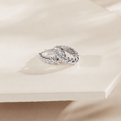 Silver ring on a light beige surface